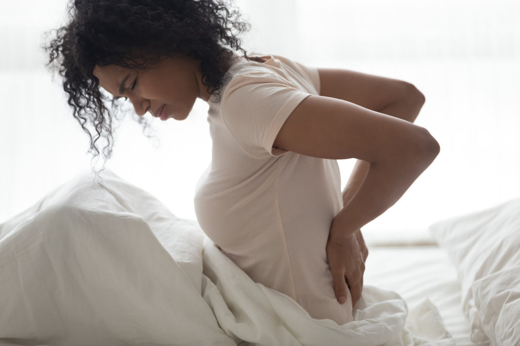 woman with back pain, mattress to relieve back pain, custom mattresses