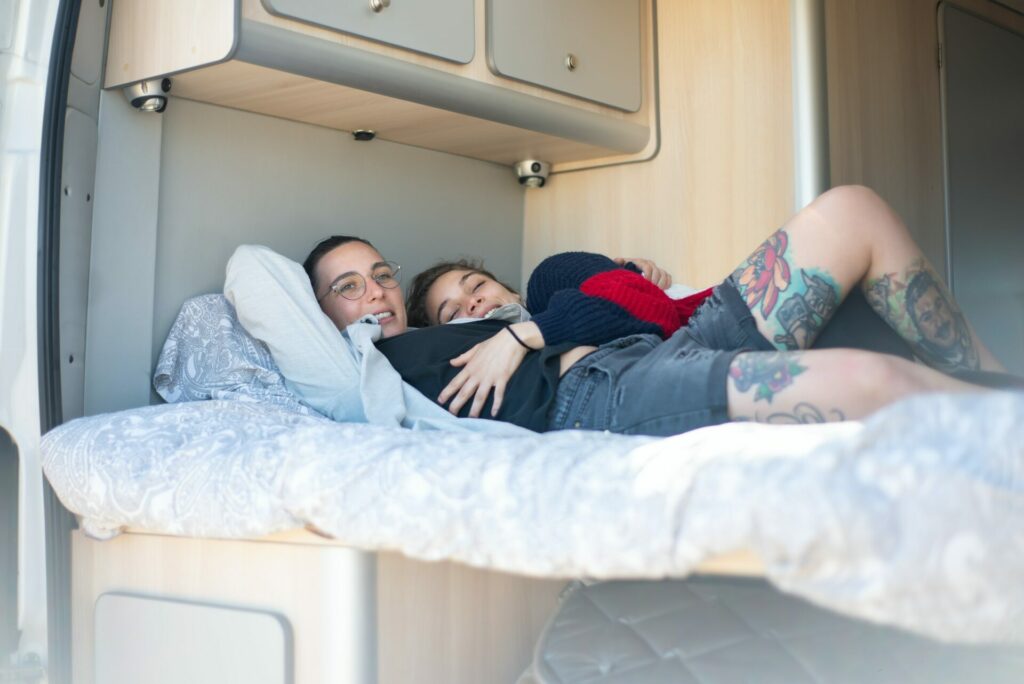 two people lying on rv mattress